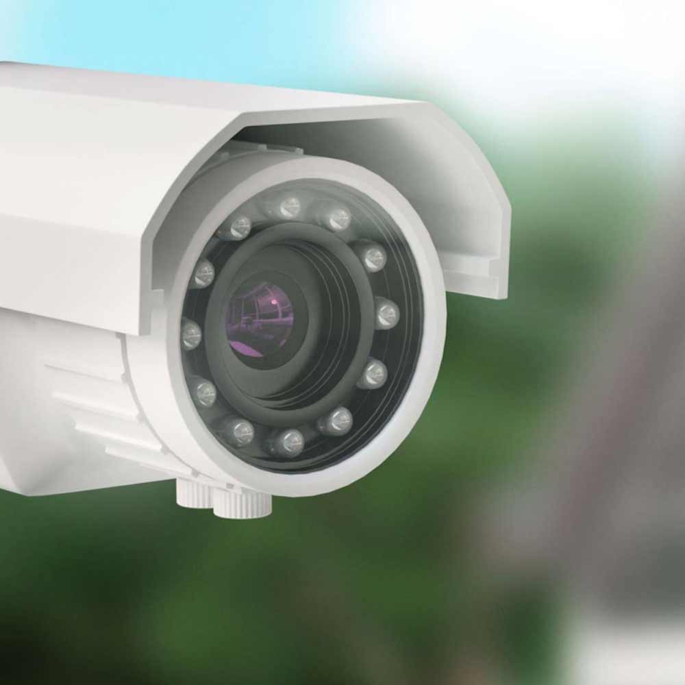 Caméra de surveillance dans un environnement sécurisé, éclairée pour accentuer la vigilance et la sécurité, une installation de Flückiger.